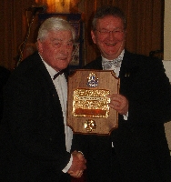 Lion Bob Woodrow (left), being presented with the Melvin Jones by PID Lion Howard Lee (right)